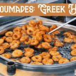 Crispy golden loukoumades recipe drizzled with honey and sprinkled with cinnamon