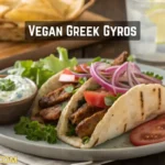 Pita bread filled with vegan Greek gyros strips, fresh vegetables, and dairy-free tzatziki